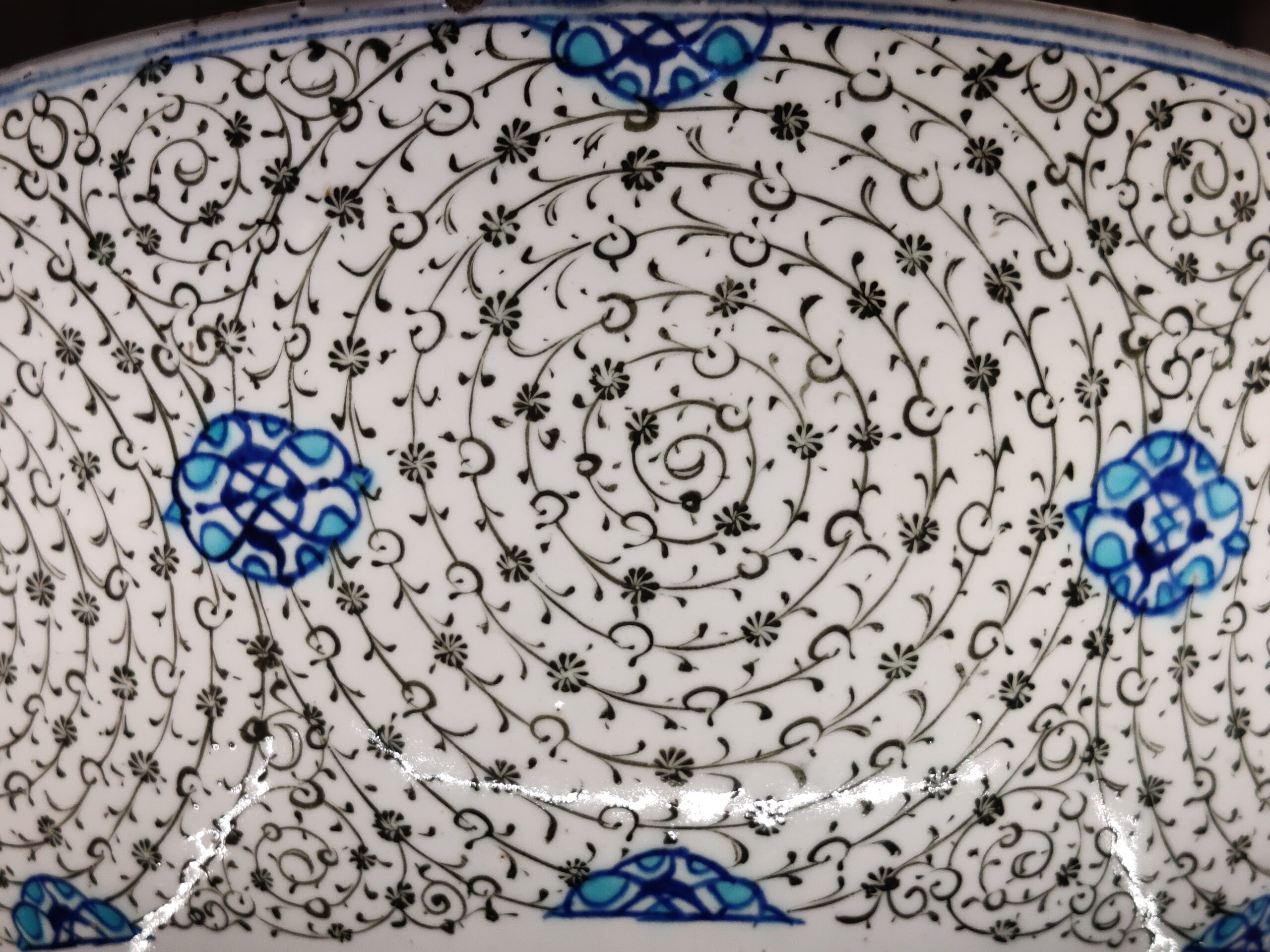 A close-up of the spiral motifs on a ceramic basin.