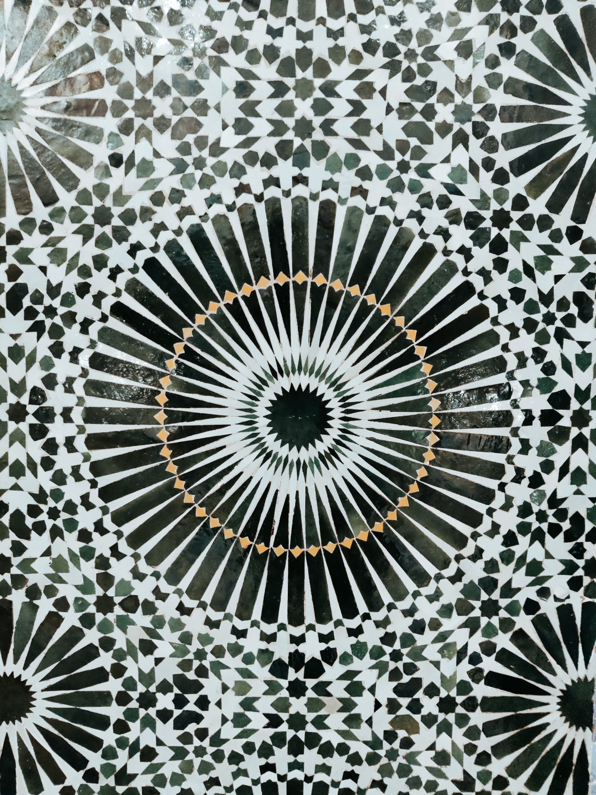 Green and white zellij ceramic wall composition.