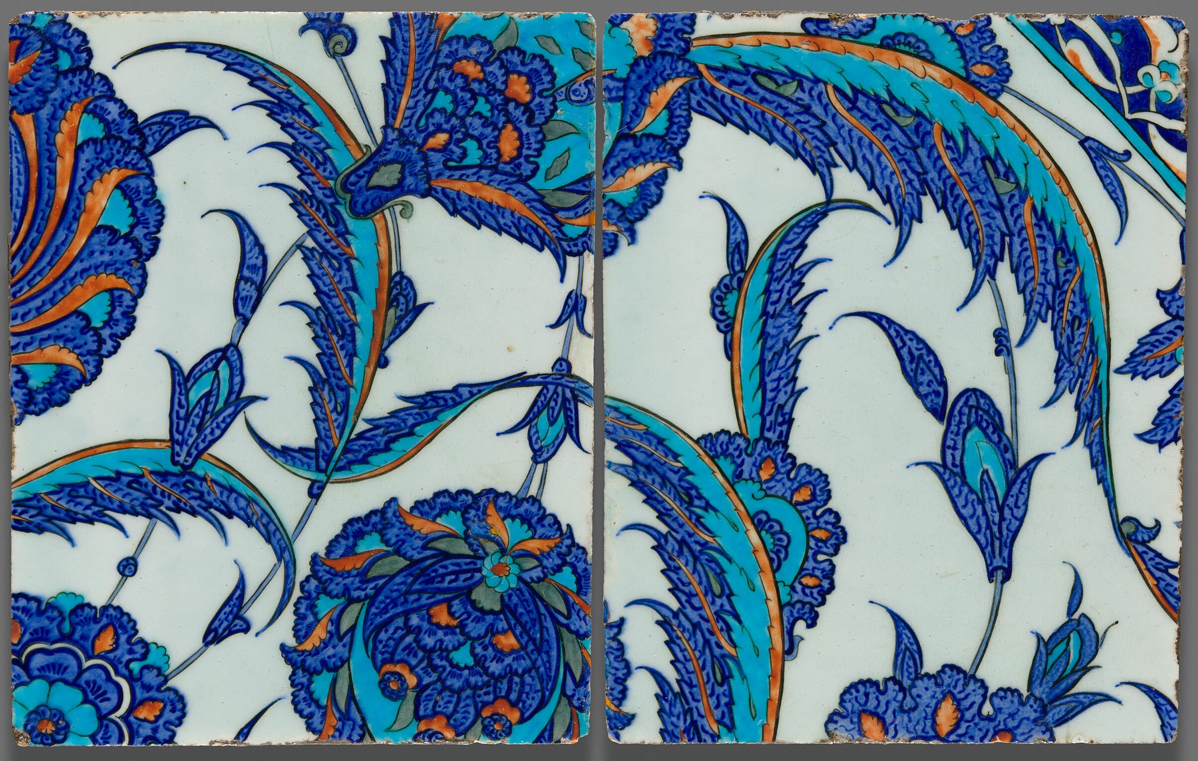 Pair of polychrome ceramic tiles with floral design.