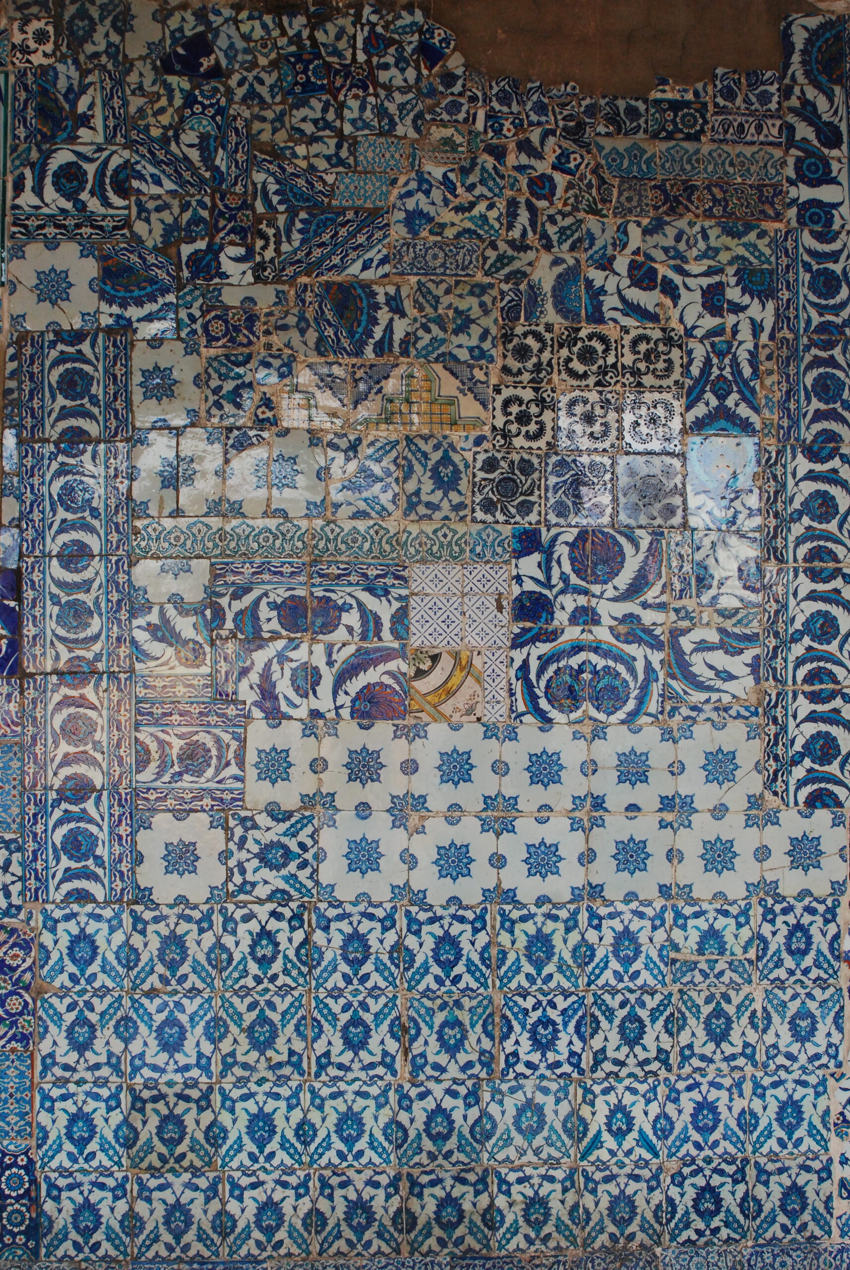 Medley of polychrome ceramic tiles covering a wall.